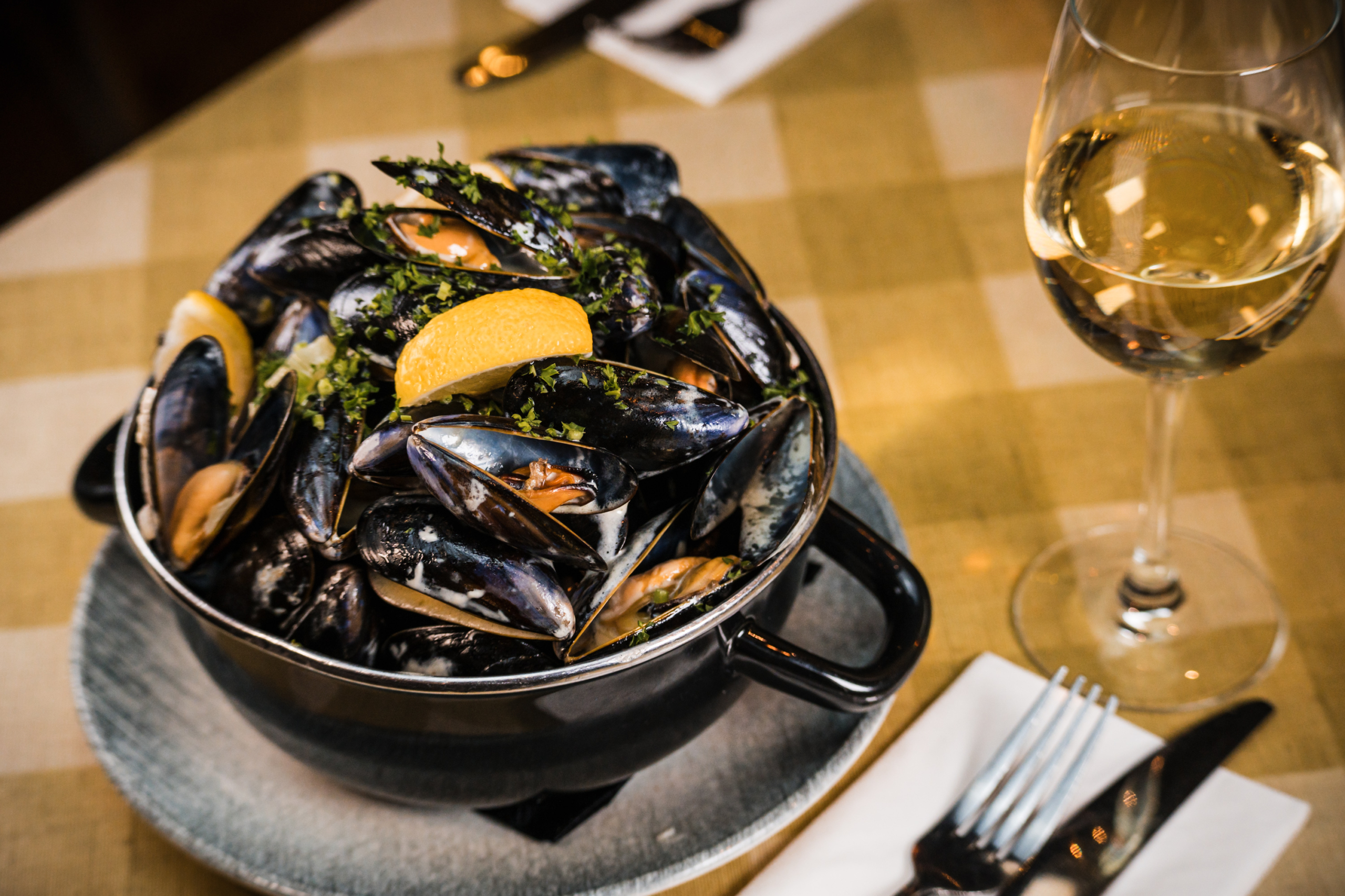 Moules marinière with a glass of white wine